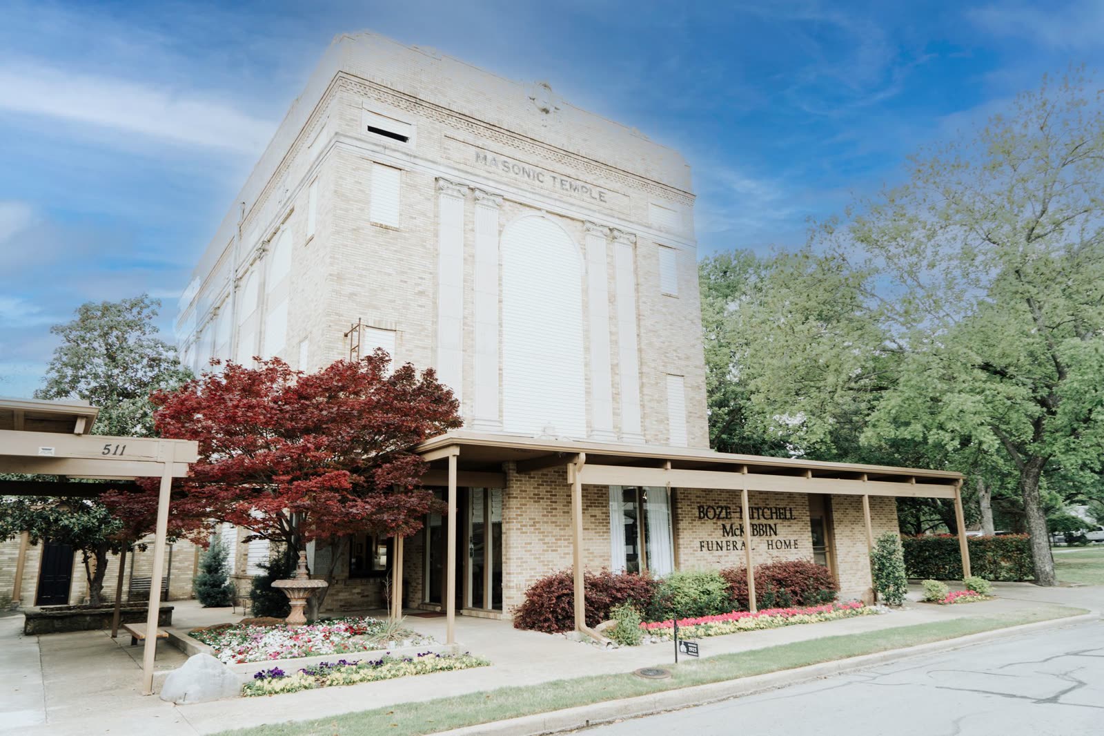 The front of Boze-Mitchell-McKibbin Funeral Home at 511 West Main Street, Waxahachie, with its flower beds and covered entrance